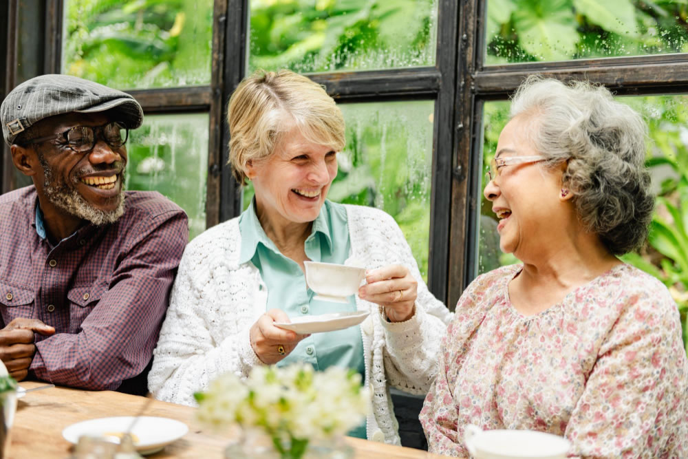 People enjoying conversation together at a table in a community space