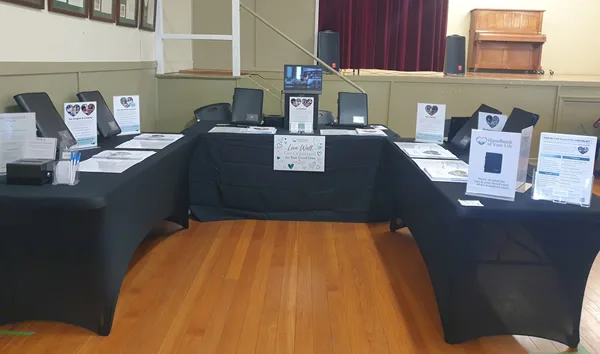 Alt text: Handbook of Your Life end-of-life planning kits and information displayed at a community expo and seminar.