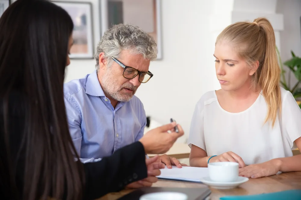 Family members discussing important documents and practical planning during a difficult life or health situation. Family members discussing important documents and practical planning during a difficult life or health situation.