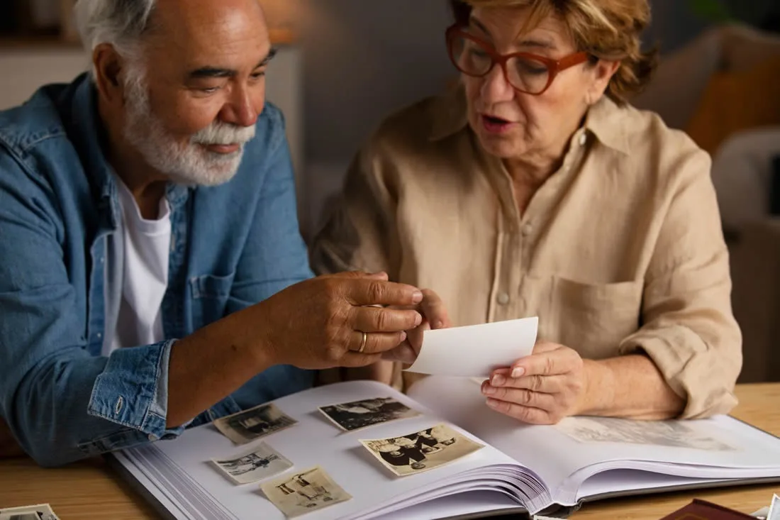 Older couple sharing family photographs and memories together