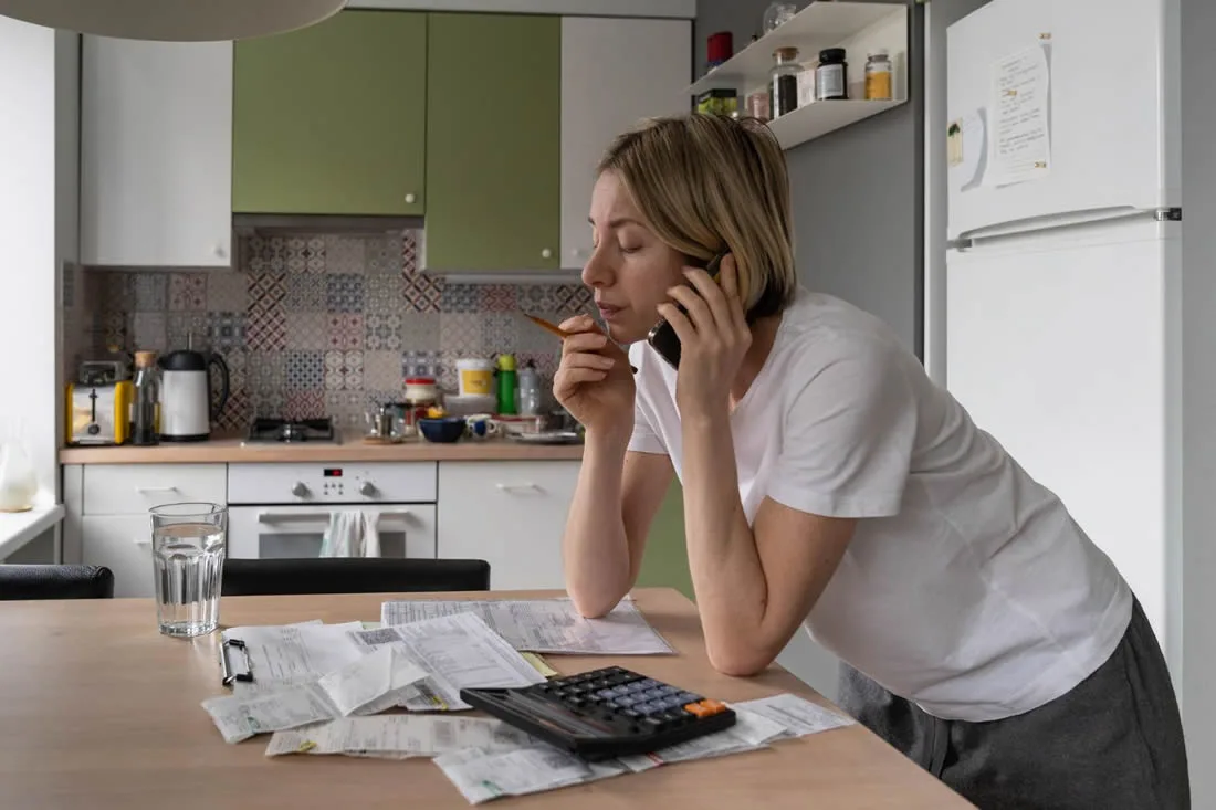 Household budget and essential bills being reviewed after an unexpected loss of income.