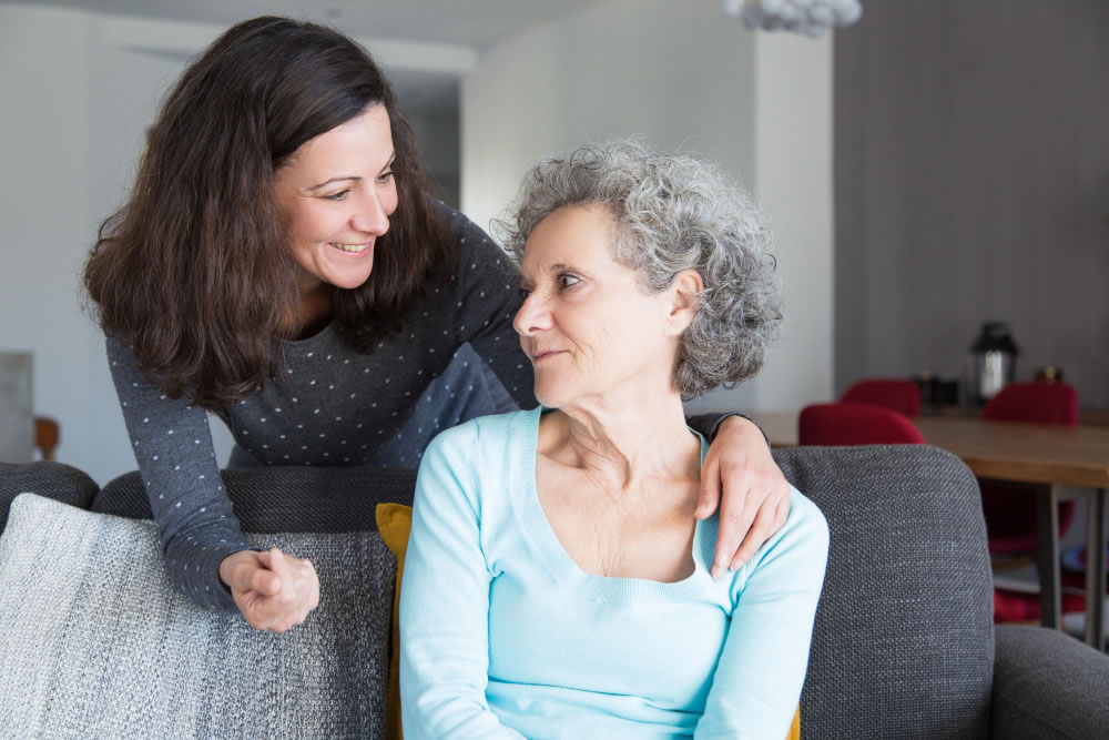 Carer providing everyday support and companionship to an older woman at home