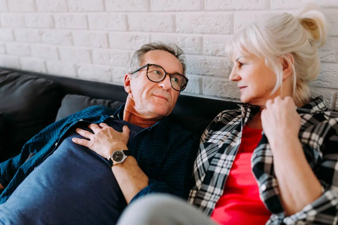 Mature couple talking together at home about the impact of prostate cancer