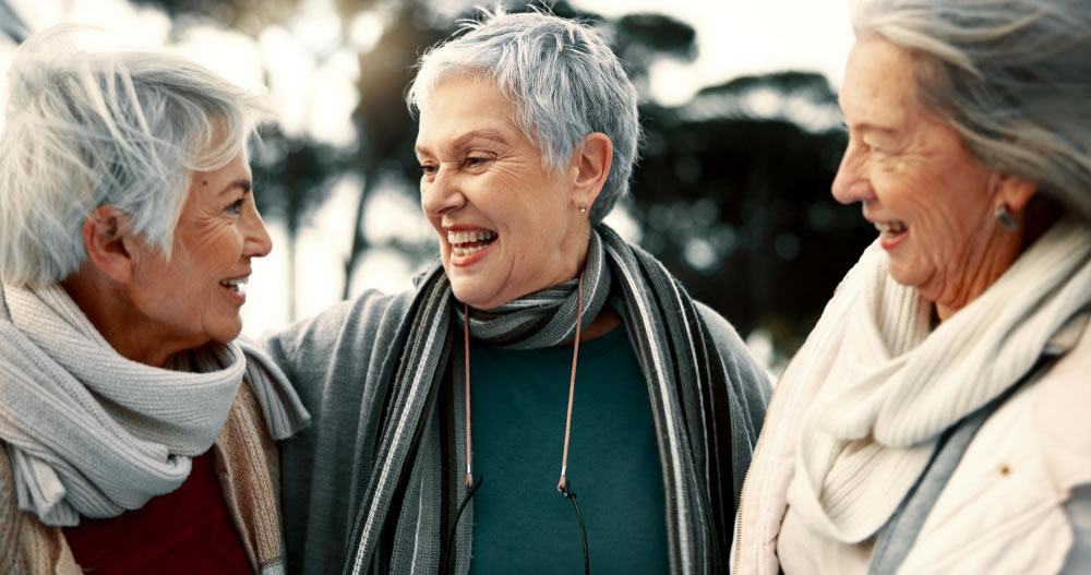 Older women enjoying connection and friendship during Queensland Seniors Month.