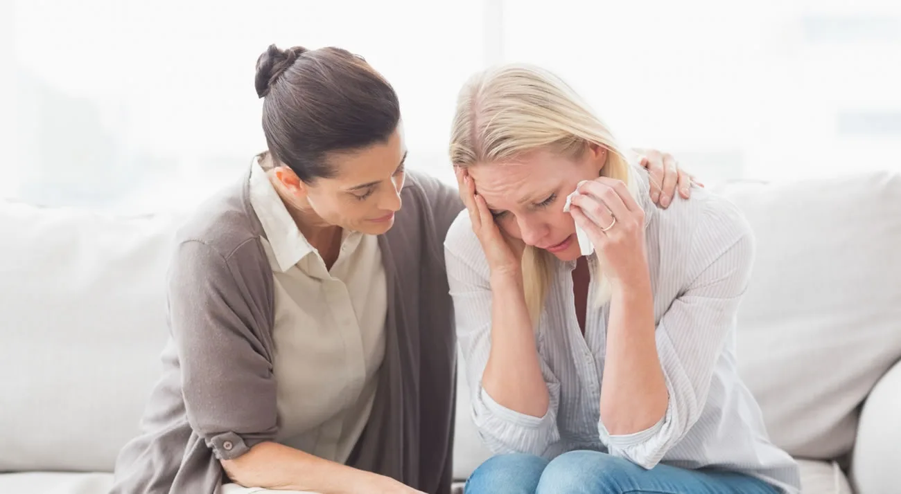 Woman offering emotional support to someone experiencing distress