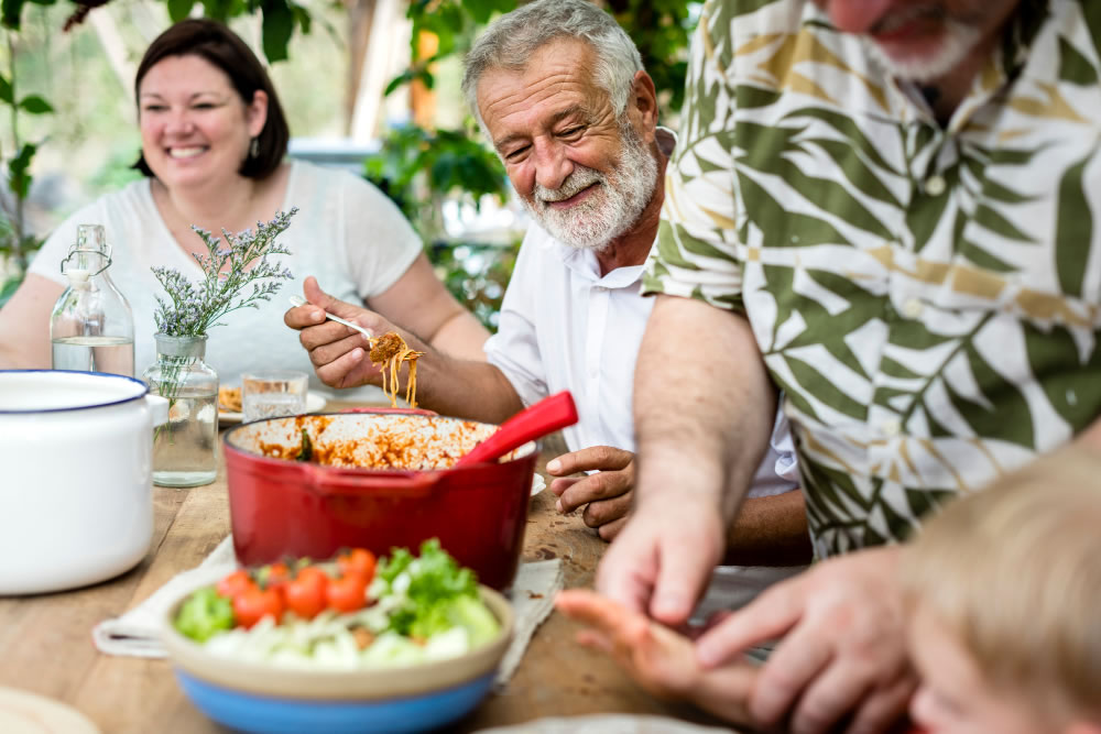 People preparing and sharing a meal together at home.